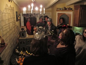 Partying People Inspecting the Ghoulish Gingerbread Haunted House