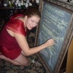 Elisabeth writes on the lab chalkboard