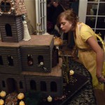 Ashlyn inspecting the Ghoulish Gingerbread Haunted House