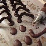 Attaching piped chocolate eyes to stalks