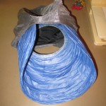 fitting the paper lantern into the fabric hat brim