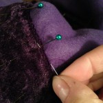 Hidden hem stitch to attach the purple velvet trim