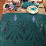 Painting the skirt with traditional rosemaling techniques