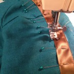 Adding the top bronze ribbon trim before fully assembling the bodice