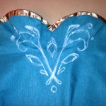 Sketching the bodice design freehand in chalk before painting