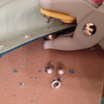 Using the eyelet tool to set the silver grommets