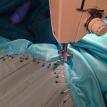 Topstitching the skirt to the bodice from the aqua side