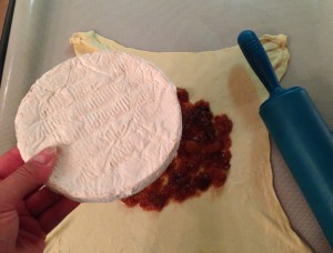 Placing the Brie on the filling and puff pastry