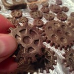Burnishing the chocolate gears with gold luster dust
