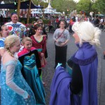 3 Elsas discussing costume details