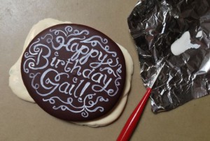 Painting ChocoWhite lettering on a custom chocolate "bar"