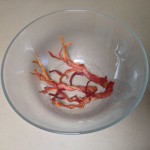Cooled baked bacon trees stored safely in a glass bowl