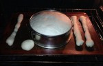 decorative Pan de Muertos bread loaf, bones and skull rising in shape before assembly