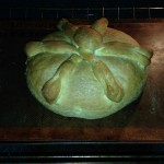 decorative Pan de Muertos loaf assembled and baked