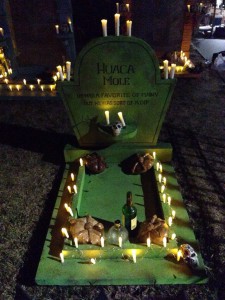 Gravestone with candles alight, some decorations, still needs FLOWERS...