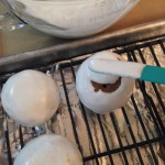 Smoothing the top royal icing after removing the fork from the cake ball