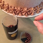 Placing the chocolate pearls in the center of each flower