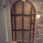 Scandinavian-inspired painted door. All the "iron" is carved & painted wood, as you can see from repairs yet to be painted. But why not paint the light-switches too? ;)