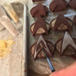 Painting both gold and silver luster dust onto the Commbadge Chocolates