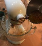 Mixing the thin ribbon of boiling sugar syrup into the bloomed gelatin