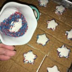 Dipping homemade marshmallow stars in red & blue pearlized sugar