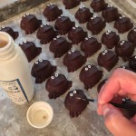 Painting eyes on the custom-molded Chocolate Frogs