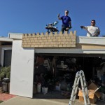 Ghoulish Glen & Scary Jerry helping hang the ramparts from the roof side