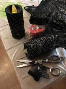 Covering pillar candles in sheer web fabric "costumes"