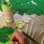 Painting veins and texture onto felt pumpkin leaves after the glue was dry for all the floral wire