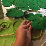 Adding the wired & painted leaves to the sisal rope while painting the rope to match...messy!