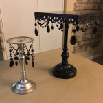 Silver candlestick and black tier tray before spider bling...