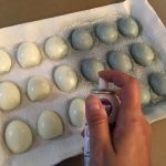Spraying edible silver on the backs of cooked egg whites